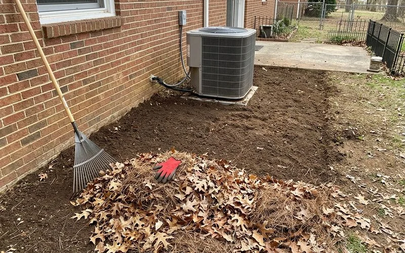 Outdoor heat pump with leaves and pine straw cleared away