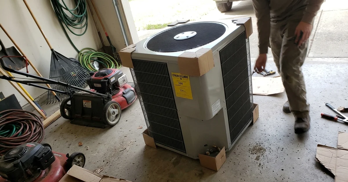 Yellow EnergyGuide label on a new outdoor AC unit in a garage