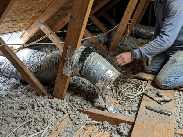 Flex duct connection with a visible gap in a hot attic