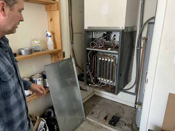 Air handler with the panel open showing electric heat strips