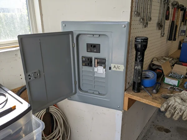 Breaker panel in a garage with the AC breaker tripped
