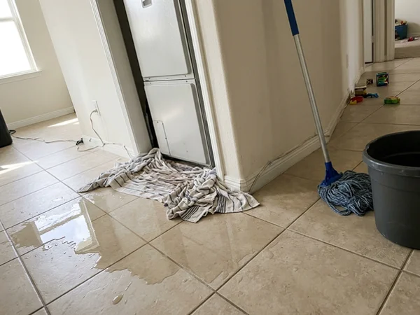 Towels around an indoor air handler after a condensate drain backup